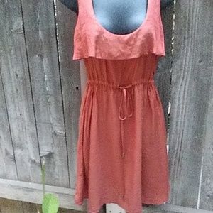 Rust colored silky dress.